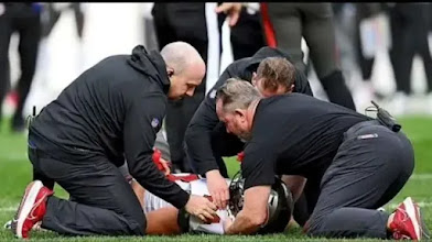 Buccaneers TE Cameron Brett walks off the field on a stretcher.