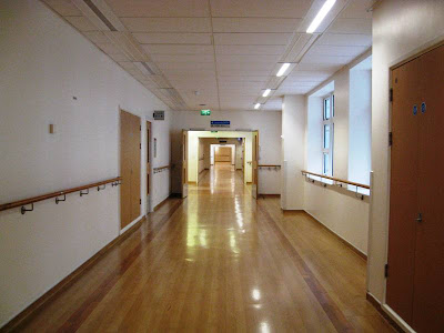 Deserted hospital corridor stretching into the distance