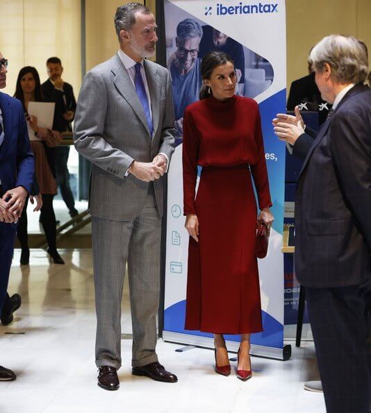 Queen Letizia wore a red open-back dress from Massimo Dutti. Queen Letizia is wearing Jose Luis Joyerias gold earrings