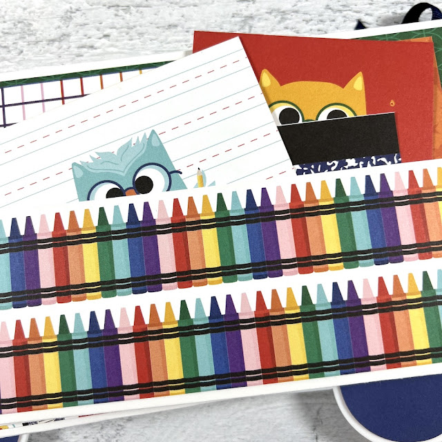 School scrapbook album page with colorful crayons, a pocket, and fun journaling cards