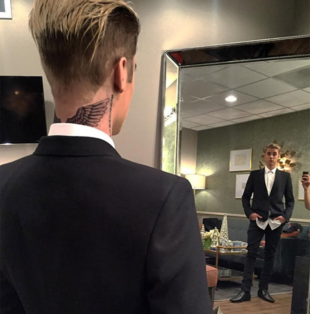 He's no angel! Justin Bieber shows off new tattoo - pair of wings on his neck