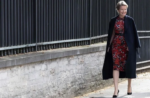 Queen Mathilde wore a new Doromos floral print midi dress by Dries van Noten. Diamond earrings and Armani pumps. Natan coat