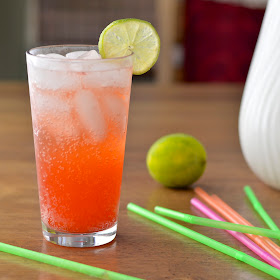 Homemade strawberry soda made with a fresh strawberry simple syrup, seltzer and a squeeze of lime.
