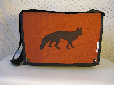 A portrait of an overshoulder handbag made of heavy nylon fabric with a fox as sewn by Aramee Diethelm