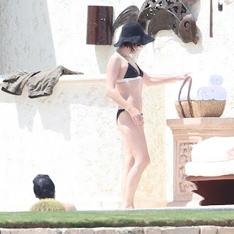 Milla Jovovich seen in bikini poolside while on vacation_35.jpg