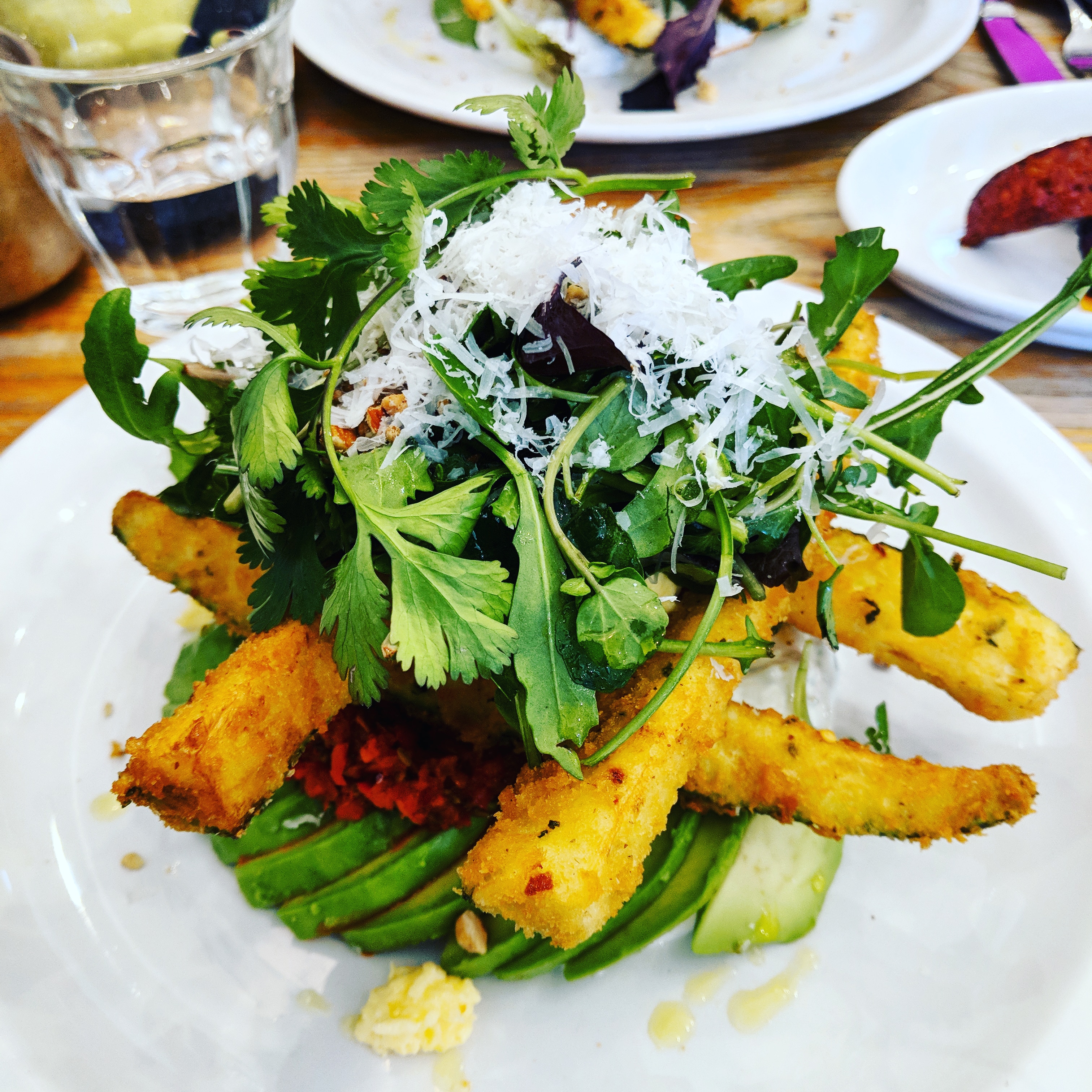 Courgette fritters stacked on avocado at Sunday Cafe in North London, it's one of the best places to get a unique breakfast in london