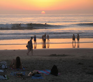 Del Mar Sunset as two surfers catch a wave