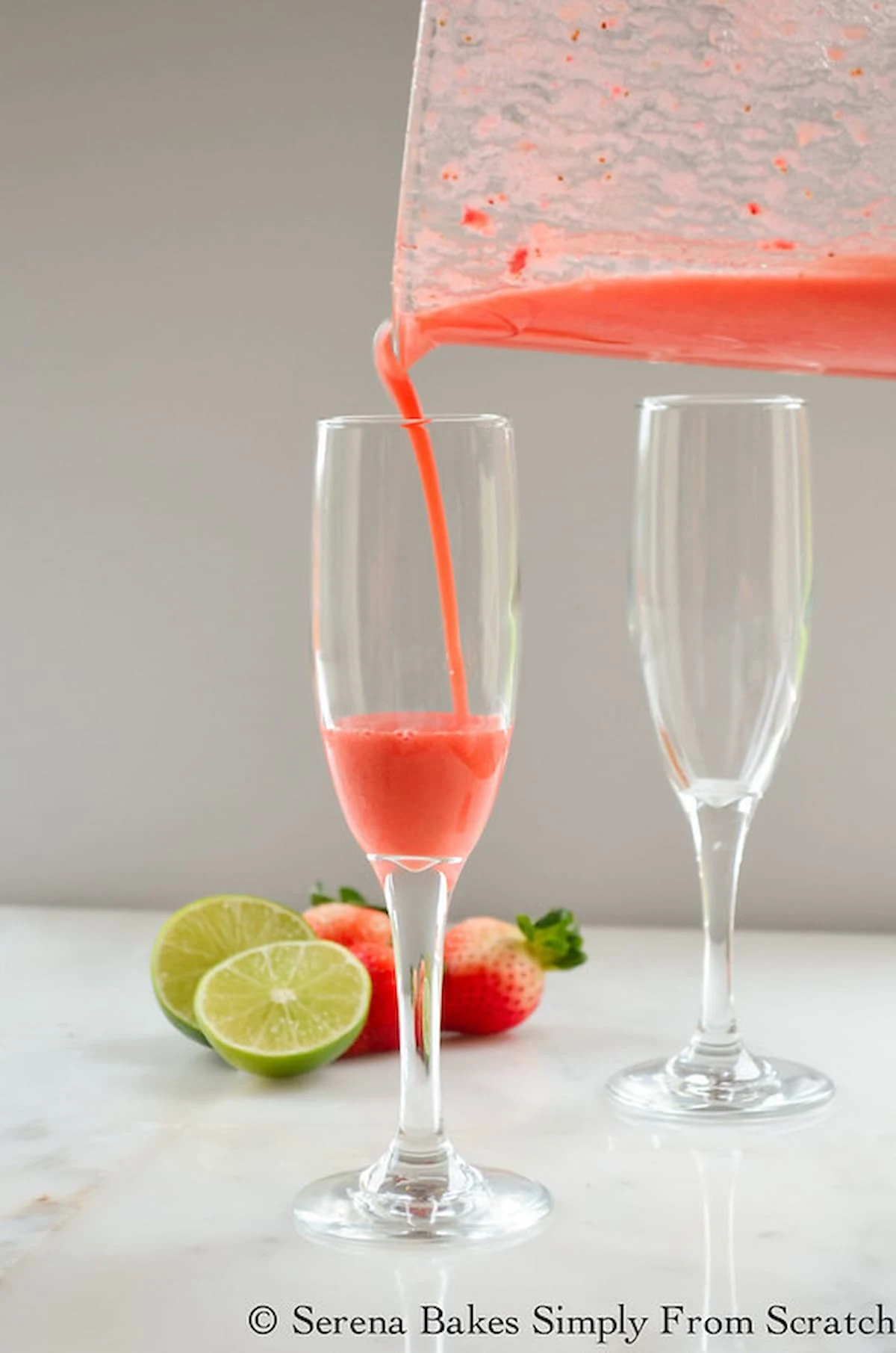 Strawberry Puree being poured into a Champagne glass.