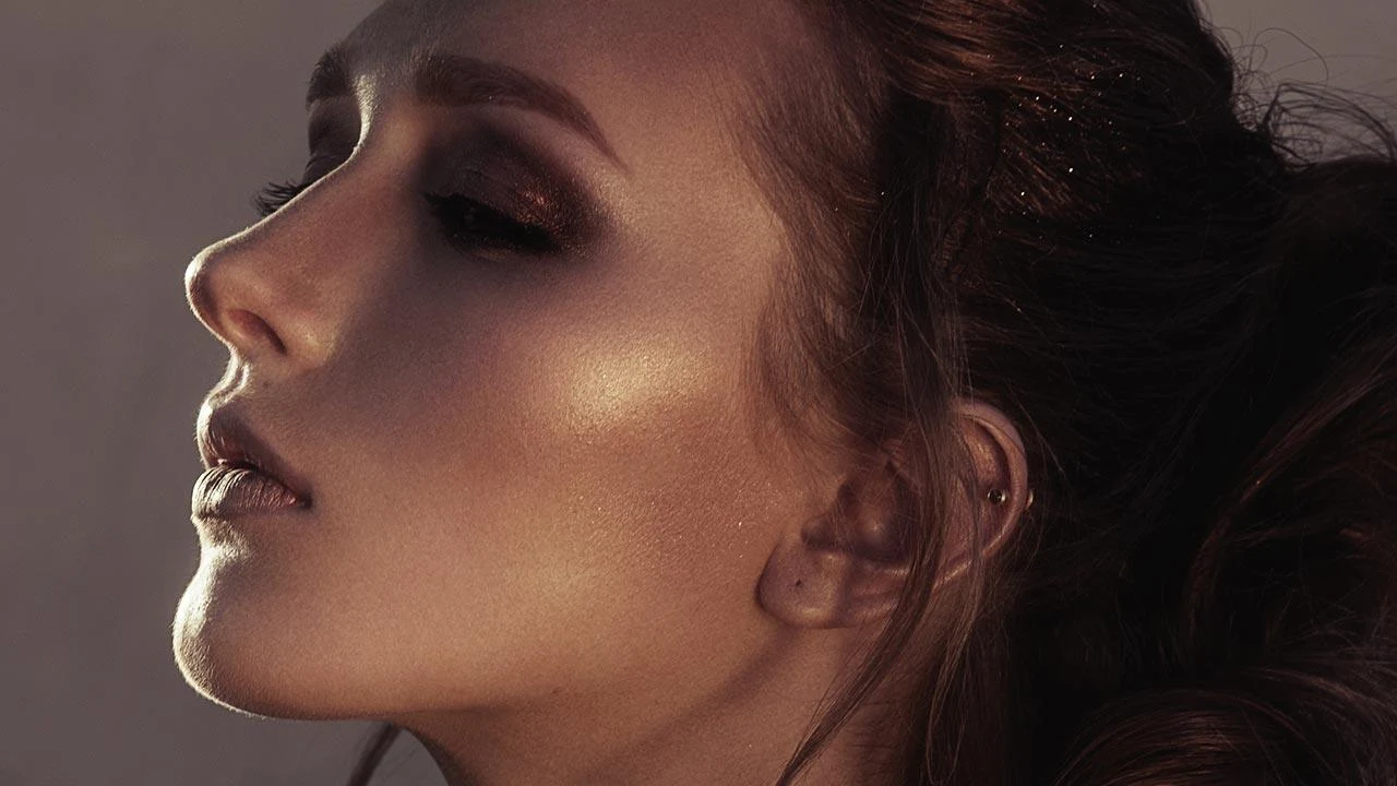 close-up portrait of a beautiful woman with gorgeous makeup look and glowing skin