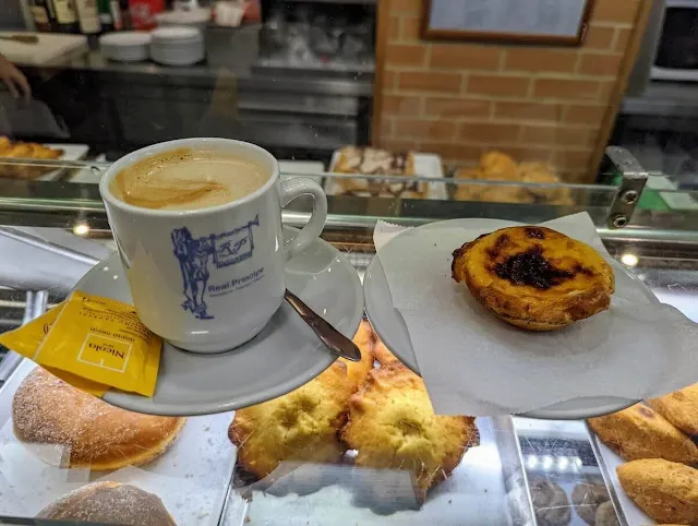 Traditional coffee with milk and pastel de nata at Pastelaria Real Principe in Lisbon