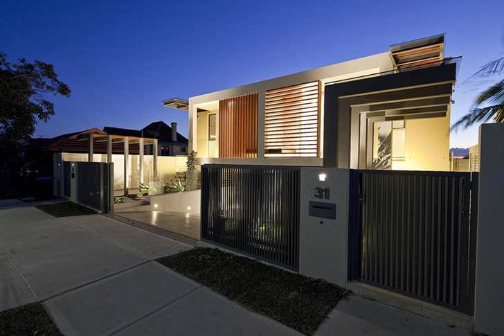 Street facade of Portland Street Duplex by MPR Design Group at night