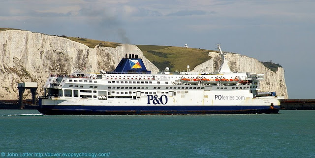 P&O Ferries' MV Pride of Calais ferry in the Eastern Docks of Dover harbour, Kent in 2010. Behind are White Cliffs of Dover at Crab Bay where a cliff fall into the English Channel happened in 2012.