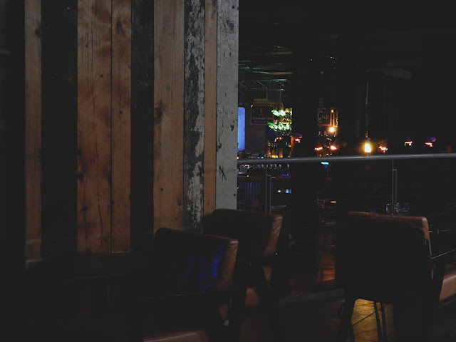 leather chairs up against wooden panel background