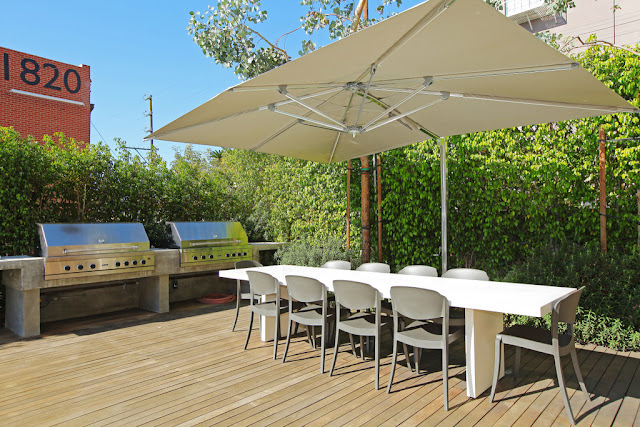 Photo of outdoor barbecue and the table on one of the terraces