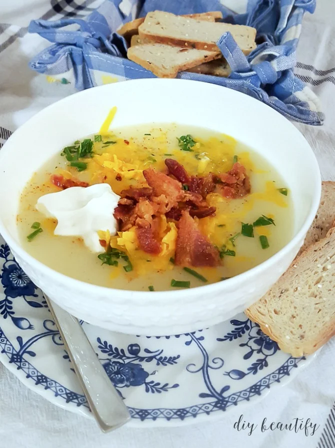 creamy potato soup with toppings and served with bread