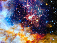 A close-up of far-away space displaying orange and white nebula and many stars