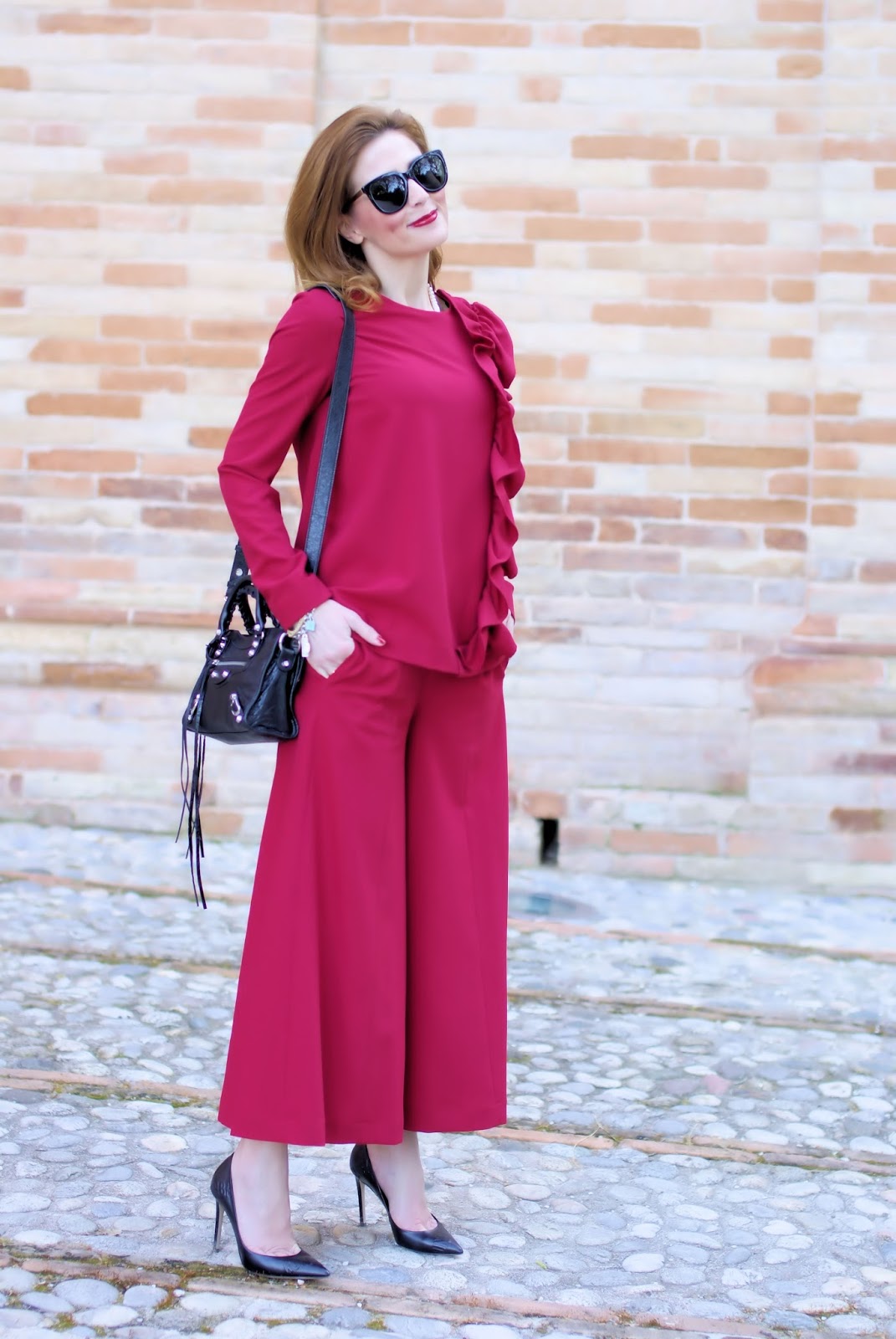 Woman in red with a ruffled blouse and wide leg cropped pants on Fashion and Cookies fashion blog, fashion blogger style