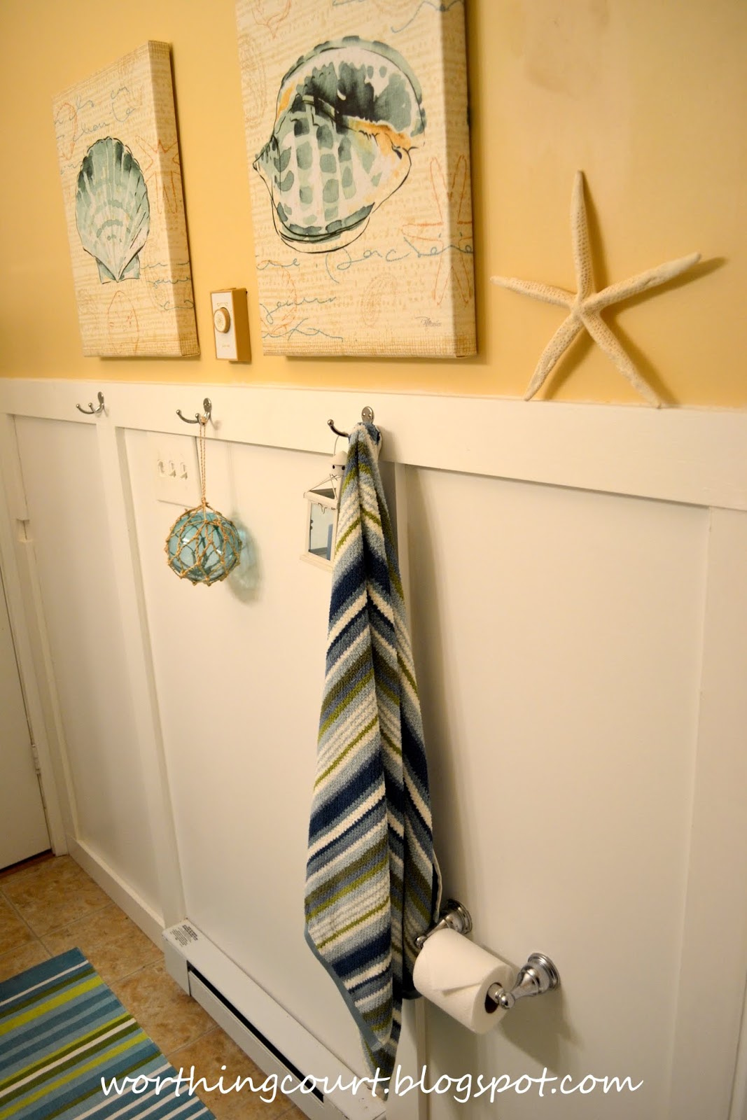 ... living room , he added a simple wainscoting treatment to the bathroom