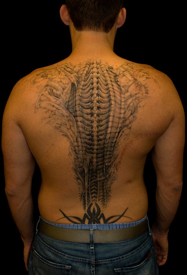 Wing and spine tattoo Wouldn't want to meet this on a dark night