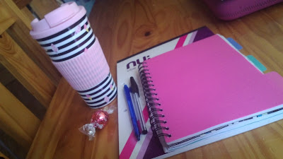 student materials and coffee mug