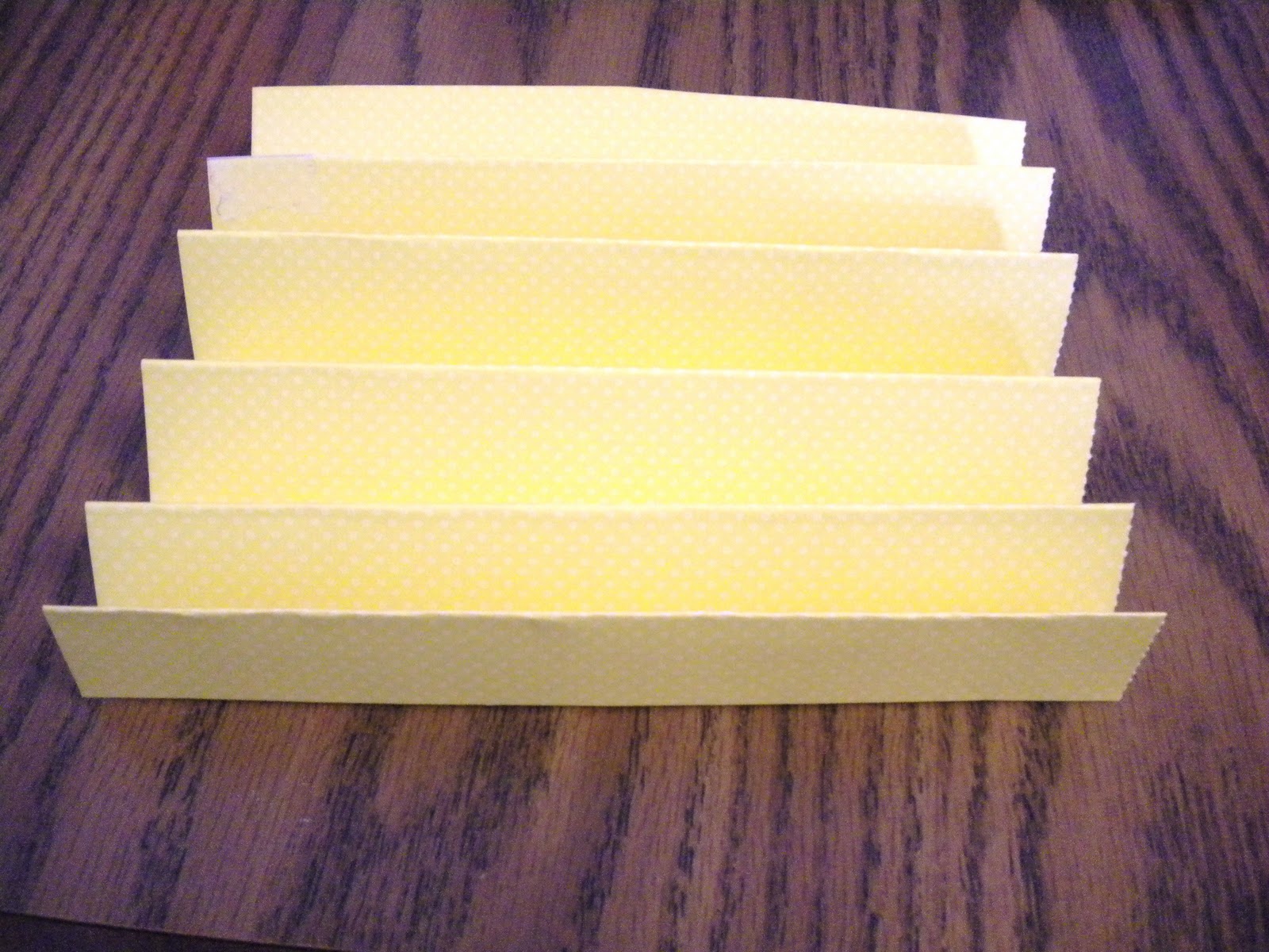 Step 3: Fold each piece of paper in half at the middle