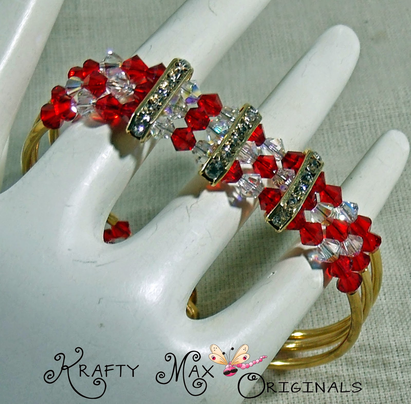 http://www.lajuliet.com/index.php/2013-01-04-15-21-51/ad/beaded,49/exclusive-red-and-clear-swarovski-crystal-and-gold-plated-triple-strand-bracelet-a-krafty-max-original-design,344
