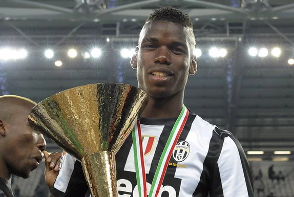 Juventus player Paul Pogba celebrates with the Serie A trophy after winning the Scudetto