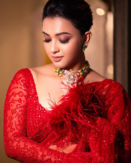 Koushani Mukherjee looking ravishing in a red saree, showcasing her hot photoshoot stills with confidence and grace.