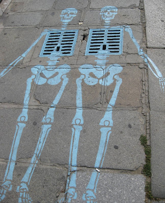 Skeletons drawn on pavement in Paris, near the Hotel des Invalides.