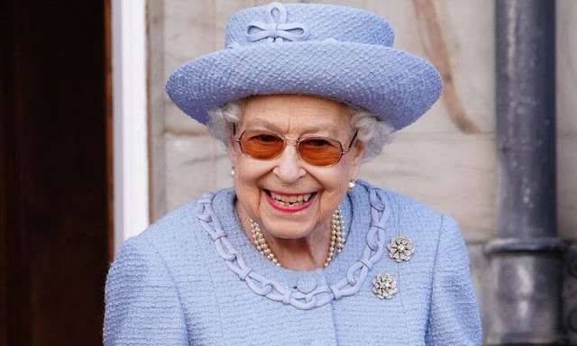 Queen Elizabeth wore a sky blue coat in the garden of the Palace of Holyroodhouse in Edinburgh