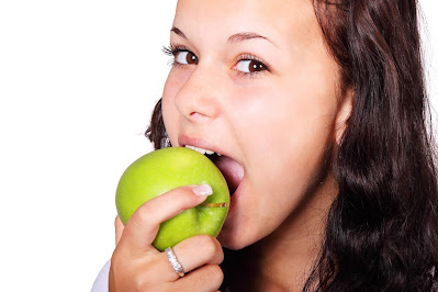 a lady eating an apple