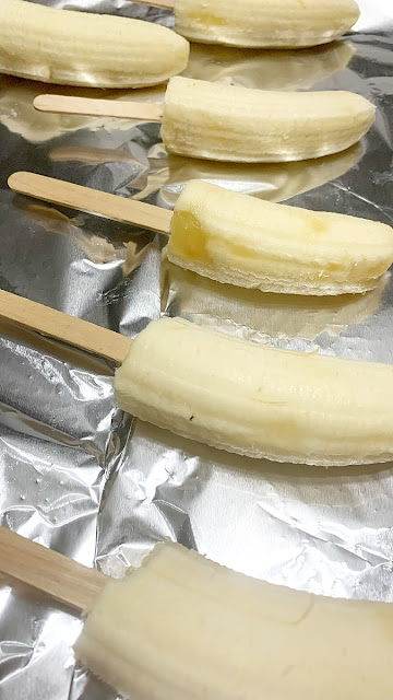 peeled bananas on baking sheet
