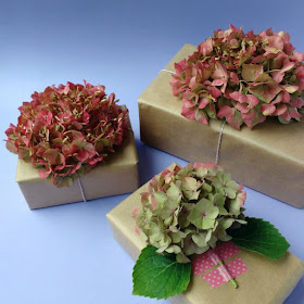 three gifts decorated with hydrangea blooms
