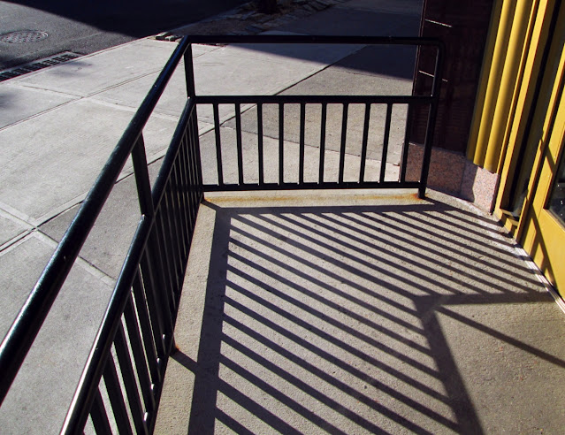 Railing shadows brilliant sunshine