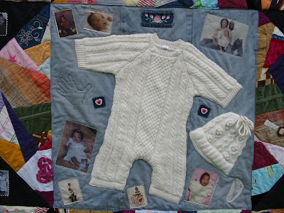 quilt incorporating whole baby clothes - onesie and hat