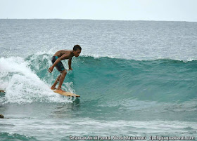 Wave Surfing in Manokwari using wooden plank