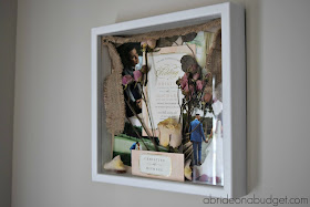 Preserve your wedding items with a beautiful DIY Wedding Flowers Shadowbox. Get the tutorial to make one on www.abrideonabudget.com.