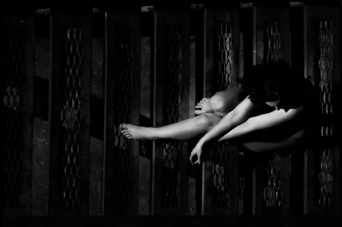 A black and white image of a girl sitting on the staircase- sad girl dp