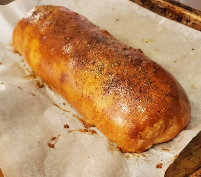 pizza dough stuffed with cheese garlic and herbs baked till golden brown