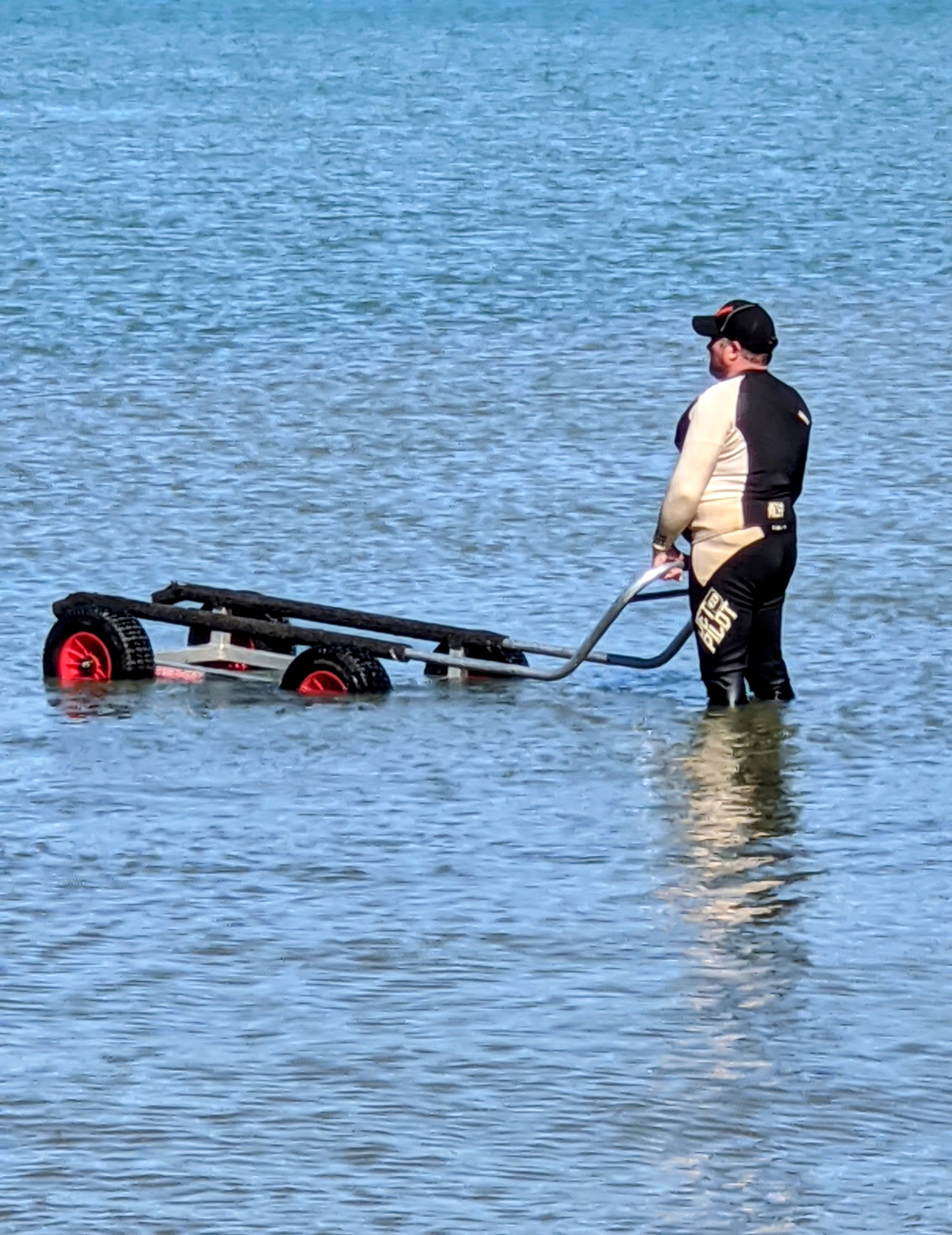 Man in water waiting for his jetski to come back.