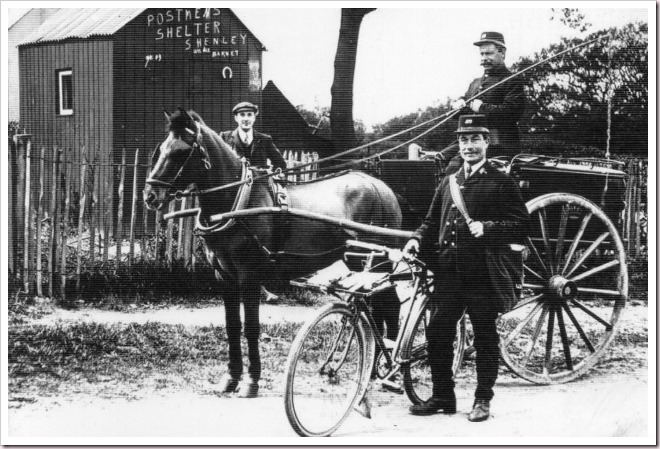 Shenley Postmen with bicycle and mail cart outside the postmen's shelter, c1909