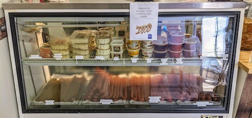 Refrigerated case with chorizo, salsas, and other products