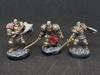 3 painted armored skeleton minis. 2 with swords, 1 with an ax