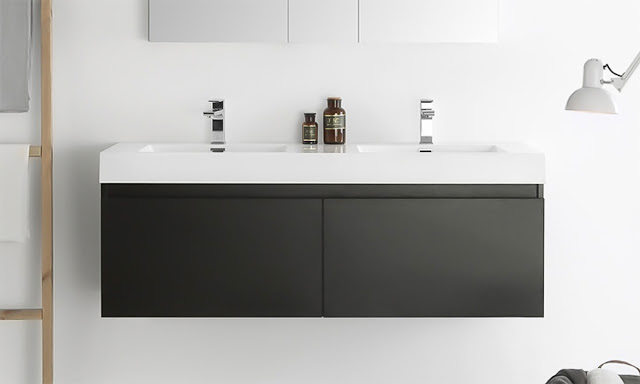 Sleek black wall mounted double vanity with white countertop in a white bathroom.