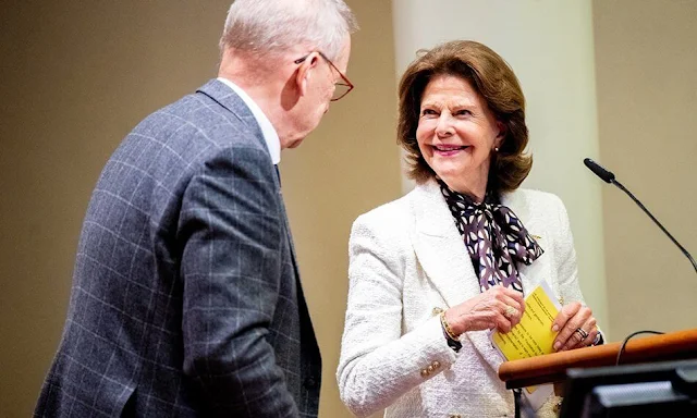 Queen Silvia wore a white textured boucle double breasted blazer by H&M. Gamla Tjanarinnor Foundation and Karolinska Institute