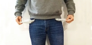 A man with no money and empty pockets standing broke