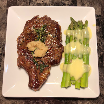 Bone-in ribeye with steamed asparagus and hollandaise