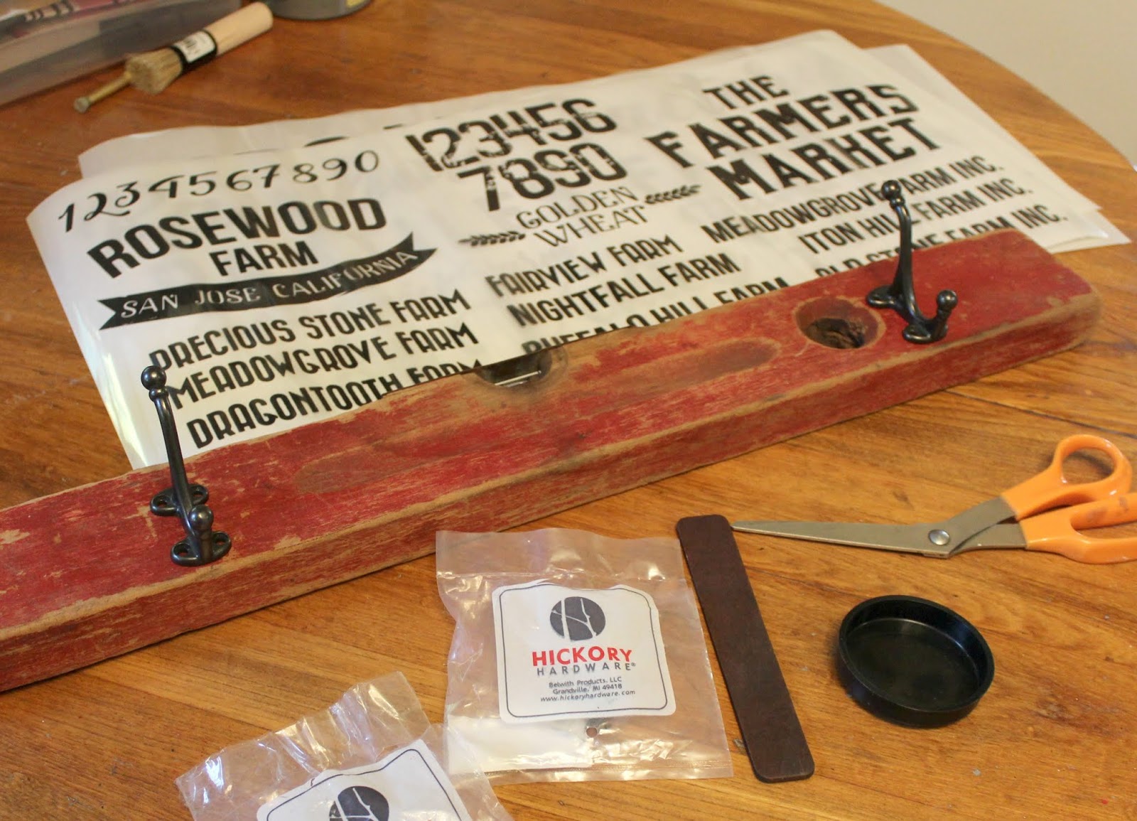 Vintage eclectic coat hooks on old wooden spirit level