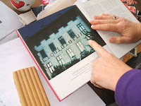 Verena Kyselka shows some of her artwork; photo by Val Phoenix