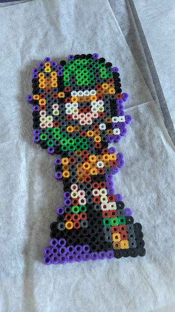 A sprite of Lucca from Chrono Trigger made from fused perler beads.